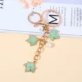 Gold-plated metal keychain with green maple leaves and initial M charm for bags - Green Pearl Style
