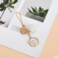 Detail of cute gold bunny charm with white pom-pom and cherry blossom design - Pom-pom Cherry Blossom Rabbit