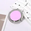 Macro view of portable folding bag hook with pink circular center and silver metal frame - Single Hook Folding Style / Pink