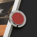 Detailaufnahme eines runden, faltbaren Handtaschenhalters mit rotem Glitzer-Finish - Rot Glitzer