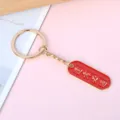 Red enamel keychain with golden 'Pass Every Exam' engraving for student gifts - Oval Pass Every Exam