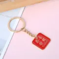 Red and gold metal keychain featuring Chinese blessing and prosperity message pendant - Square Gong Xi Fa Cai
