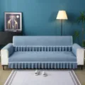 Cozy living room scene featuring a blue quilted sofa cover with elegant white lace trim detail. - 1-Seater 90*90CM / Always with You Grey