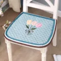 Detail shot of blue quilted chair cushion featuring 3D embroidered tulip flowers and border. - Tulip Embroidery / 44x45cm / Green
