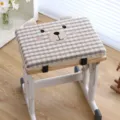 Close-up of cute bear patterned rectangular seat cushion with grey stripes on wooden chair. - Sweet Brown Bear Grey