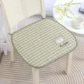 Close-up detail of green plaid chair cushion with cute bear embroidery and text design. - Good Morning Bear Green Quilted Non-Slip