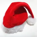 Close-up detail of a red gold velvet Christmas hat with thick white plush trim and pom-pom - Long Plush Composite Style (RM203-6)