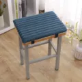 Detailed shot of a thick blue corduroy seat cushion with straps on a stool for winter warmth. - 35CM*25CM / Horizontal Stripe Rabbit Plush Dark Blue
