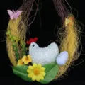 Detail of Easter vine wreath decoration with foam chicken, egg, and yellow flowers - Laying Hen Decoration Style
