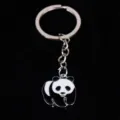 Macro detail of cute panda metal keychain showing black and white enamel craftsmanship. - 熊猫12款式