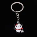 Close-up of a cute metal panda keychain with red scarf on black background - 熊猫05款式