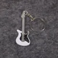 Macro view of a white electric guitar keychain with detailed strings and pickguard. - White