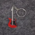 Close-up view of a vibrant red electric guitar keychain with intricate metal fret details - Red