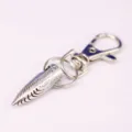 Close-up of a silver metal spike keychain featuring a detailed wood grain texture - Spiral Cone Style (2)