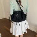 Chic black nylon shoulder bag with stylish buckle flap and unique drawstring details - Black