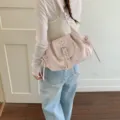 Casual soft pink nylon shoulder bag featuring a stylish silver belt buckle flap design - Pink