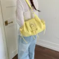 Casual yellow nylon commuter shoulder bag with belt flap and drawstring detail - Yellow