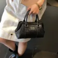 Elegant black embossed woven handbag with metallic logo for women's daily casual use - Black