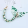 Close-up of green floral scarf phone lanyard with gold chain and double clasps - Style B