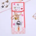Detalle del llavero de gato de la suerte Maneki-neko de cerámica con etiqueta de joya - Negro