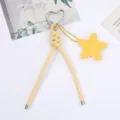 Detailed view of yellow PU leather braided cord with silver heart carabiner and star charm - Yellow