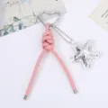 Close-up of pink PU leather braided keychain with heart carabiner and star charm - Pink