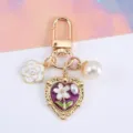 Elegant vintage heart keychain with pearl and camellia flower charms for bag decoration - Purple