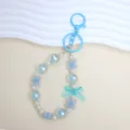 Light blue beaded phone charm with bow and lucky clover elements for bag decoration - Lake Blue