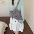 Women's casual grey nylon shoulder bag with a unique belt flap and drawstring detail - Gray