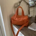 Elegant orange lychee grain leather handbag with adjustable strap for women's commute - Single Bag Style / Orange
