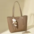 Elegant minimalist brown commuter tote bag featuring a cute plush bear charm - Mud Brown