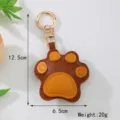 Detail view of cute leather cat paw keychain showing 12.5cm height and 6.5cm width dimensions - Khaki