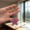 Detailed macro view of pink rhinestone star keychain showing 13.1cm length and 36.5g weight - Pink