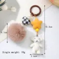 Detailed view of cute flocked white bear keychain with brown pom pom and star charms - White Bear