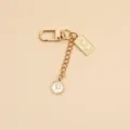 Detail showing gold vintage alloy keychain with Elizabeth II coin pendants - Round Plate Clasp (037-3)
