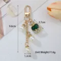 Detailed view of fashion green crystal perfume bottle keychain with pearl charms - Dark Green
