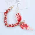 Detail view of red and white silk scarf phone chain with gold metal lobster clasps - Style R
