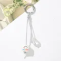 Detail view of cute bag charm featuring a 'smile' cube bead and silver ring - Square Pearl