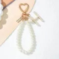 Elegant pearl initial H keychain with gold heart clasp and wrist strap detail - Letter H Style / Pearl White