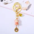 Detailed macro view of a cute pink ceramic monkey zodiac keychain featuring a golden bell charm - Monkey