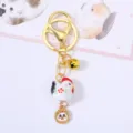 Detailed view of a cute ceramic chicken zodiac keychain with golden bell and charm - Rooster