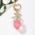 Detail of sweet pink strawberry keychain with rhinestone bow and heart clasp - Transparent Pink