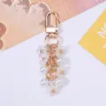 Elegant sweet cherry blossom keychain with white pearls and gold lobster clasp detail - White