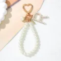 Detailed close-up of a pearl letter A keychain charm featuring a rose gold heart-shaped clasp. - Letter R Style / Pearl White