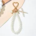 Detailed view of a pearl keychain with heart clip and a letter X charm pendant. - Letter X Style / Pearl White
