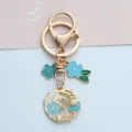 Gold floral wreath keychain with blue enamel cherry blossoms and delicate pearl accents - Pearl Flower Style (A026) / Blue