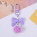 Adorable purple resin bow keychain featuring pink fluffy pom-pom and faux pearls - Purple
