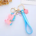 Detail showing pink unicorn keychain with blue strap, rainbow and shell charms. - Wing Integrated Style / Blue Back