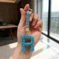 Detail of turquoise rhinestone letter R keychain with sparkly crystal finish - Letter R