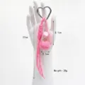 Detail shot of a pink heart-shaped tennis racket keychain with size and weight labels - Pink